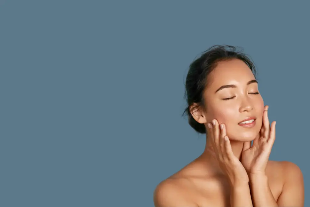 Woman with relaxed facial muscles touching her face, representing Botox treatment at Lazaderm